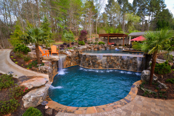 A vanishing edge pool blending seamlessly with flagstone and natural boulders.