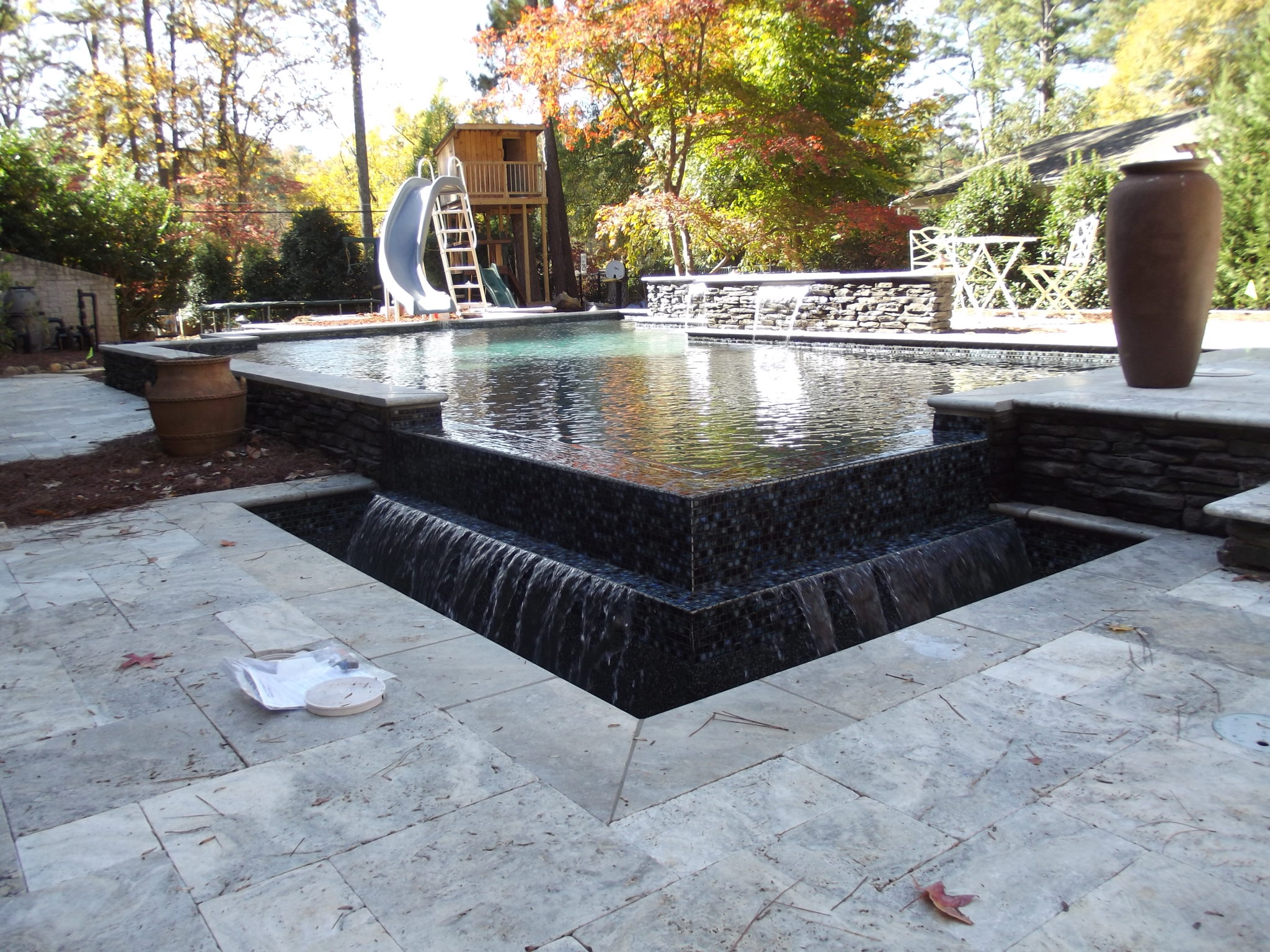 A stylish modern vanishing edge pool featuring black tile.
