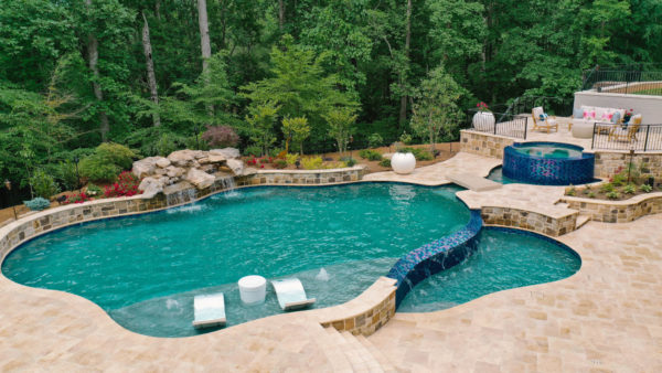 A vanishing edge pool with a flagstone finish blending seamlessly into the landscape.