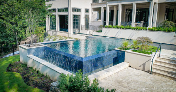 Custom straight line pool with raised doors for indoor-outdoor connectivity.