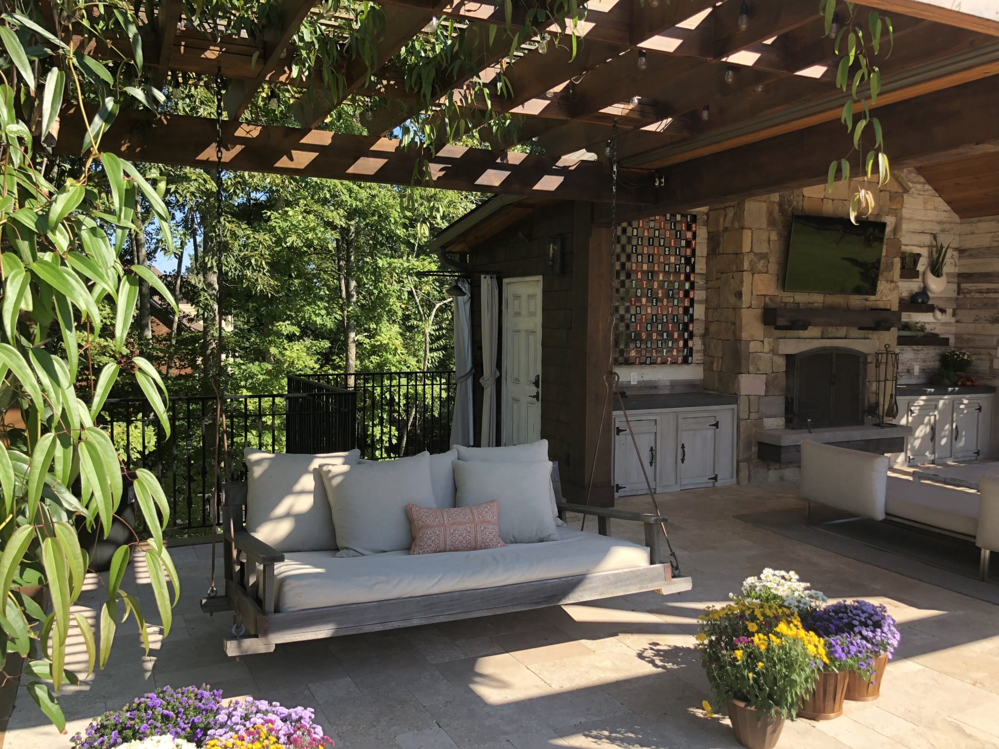 A tranquil swimming pool surrounded by a pergola, featuring a delightful swing for a serene and stylish outdoor escape.