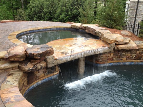 A luxurious custom spa with a sheer waterfall and grotto.