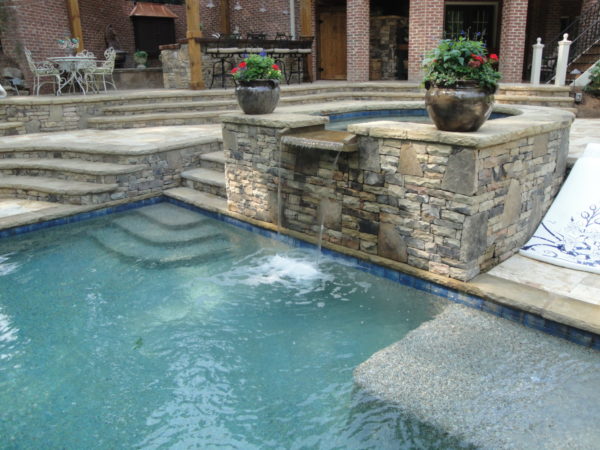 A U-shaped spa with a serene spillover, offering a luxurious and tranquil addition to your outdoor haven.