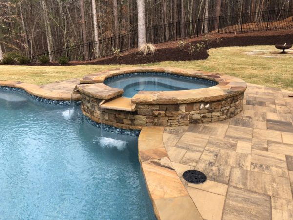 A circular spa with a graceful spillover, adding a touch of elegance and serenity to your outdoor sanctuary.