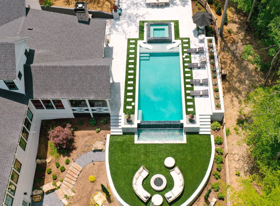 Relax in understated luxury on the travertine pool deck, with the modern pool as your backdrop