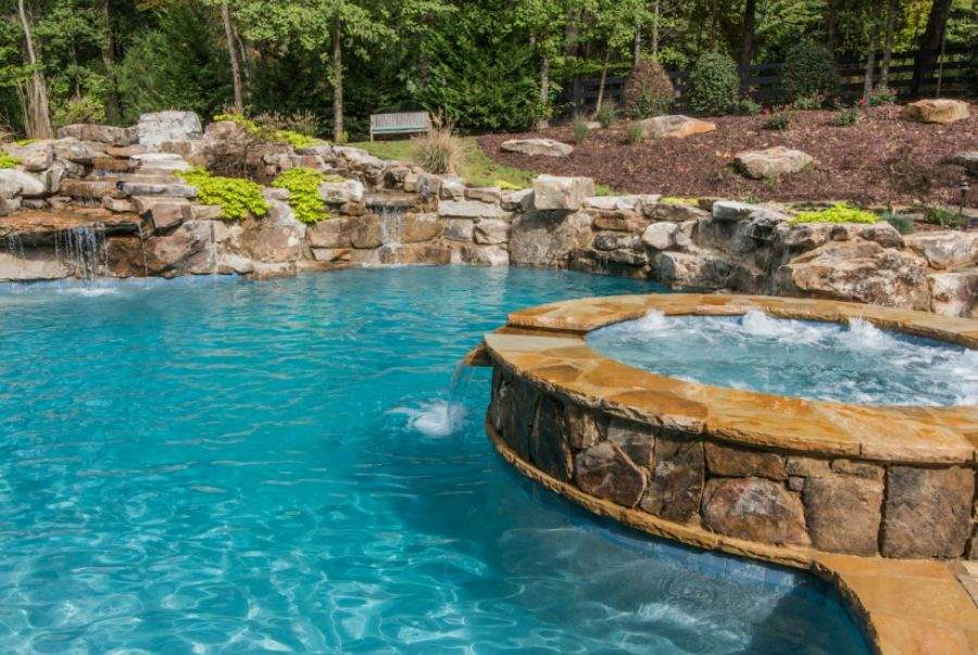 A Pool With A Waterfall And Rocks