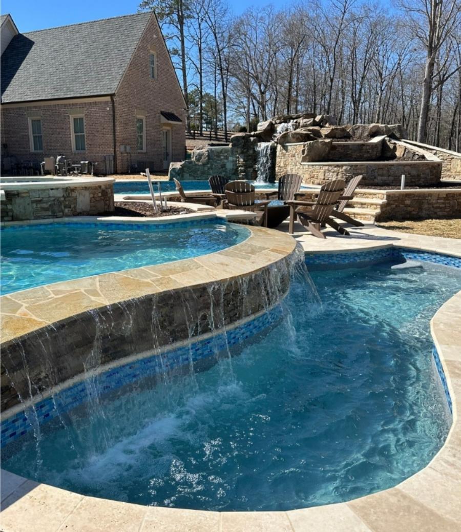 Pool With A Waterfall And A House