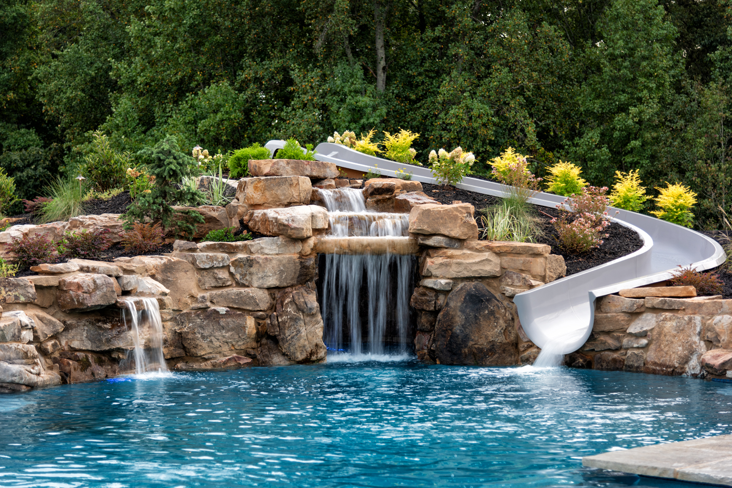 Luxurious pool with a grotto, waterfall, and large boulders in Chipper Jones' backyard, designed by Georgia Classic Pool.