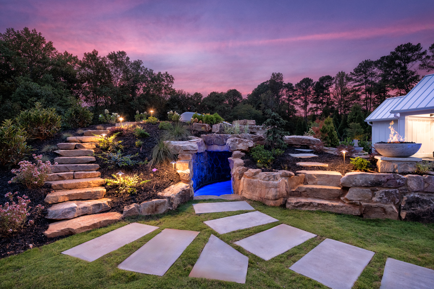 Luxurious pool with a grotto, waterfall, and large boulders in Chipper Jones' backyard, designed by Georgia Classic Pool.