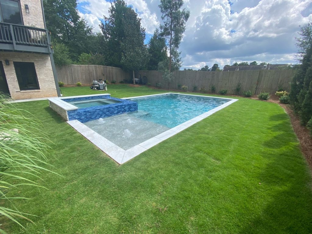 Classic rectangular pool with raised tile spa and tanning ledge bubblers